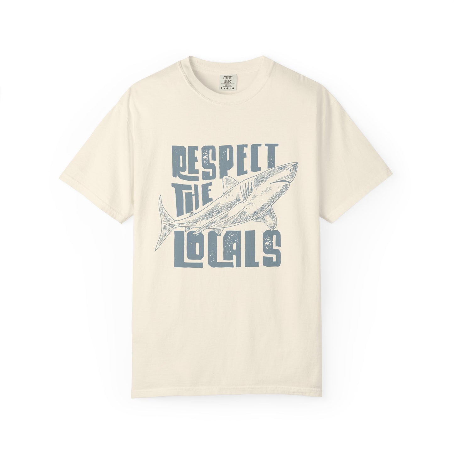 Beige t-shirt with a graphic of a fish and text 'Respect the Locals' on a white background