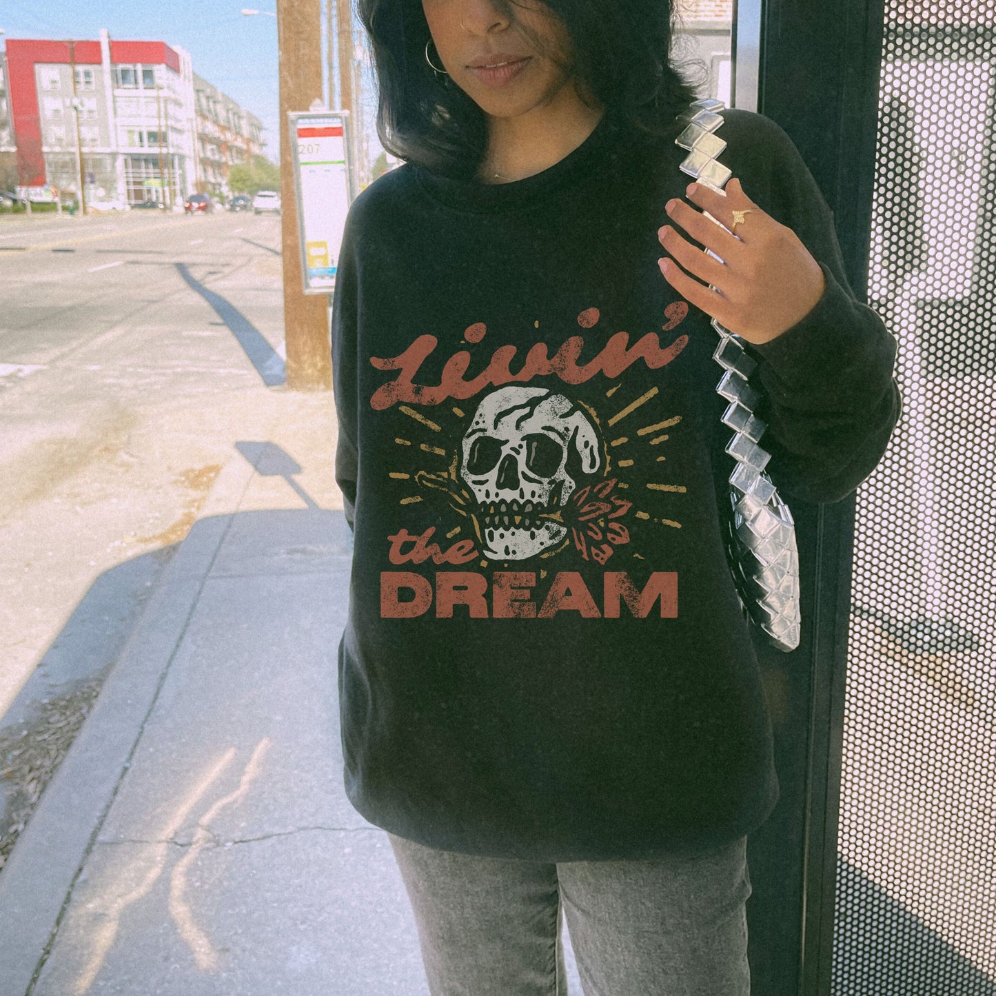 Oversized retro skull sweatshirt with bold vintage-inspired design. Livin' The Dream shirt featuring edgy graphic details. Perfect boho skull pullover for grunge and aesthetic styles. Casual vintage skull sweater ideal for layering and everyday wear.