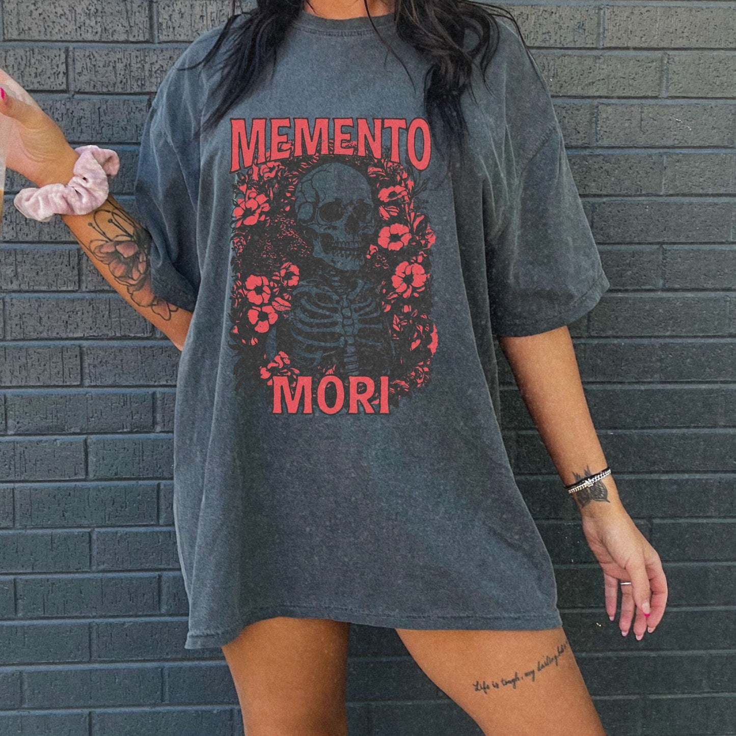 Graphic tee featuring a detailed skull design surrounded by floral elements, perfect for fans of vintage skeleton tees, gothic skull shirts, and retro goth style. A trendy death-themed shirt combining dark floral and skeleton art for casual or streetwear looks.