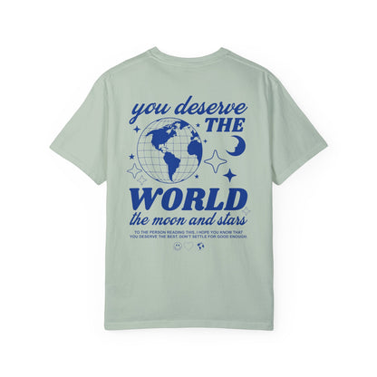 Motivational graphic t-shirt with a celestial design featuring stars, moon, and globe. Includes the inspiring phrase 'you deserve the world.' A trendy and stylish vintage-inspired tee for casual wear, perfect for spreading positivity and empowerment.