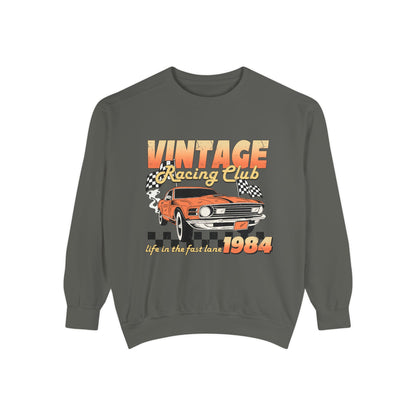 Retro car club shirt with vintage 1984 race car graphic, distressed design, and checkered flag accents. Perfect for muscle car lovers and fans of classic racing. Available as a crewneck sweatshirt in multiple colors.