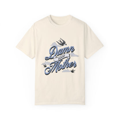 T-shirt with "Damn Good Mother" design in vintage tattoo style. Retro mama t shirt with bold mom statement and bird illustrations. Cool mom graphic tee perfect for Mother’s Day gift or everyday wear. Trendy mom gift tee with edgy mom tee shirt vibes. Stylish mom shirt for confident, fun-loving mamas. Unique cute mom saying tee with rad mama energy. Tattoo style mom tee that makes the perfect bold mom statement piece.