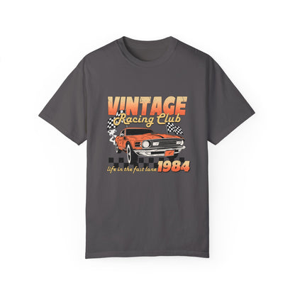 Retro racing T-shirt featuring a bold 1984 vintage design with distressed car graphics. Perfect nostalgic car shirt for muscle car lovers, featuring checkered flag details. Ideal for fans of old school racing and fast lane graphic tees.