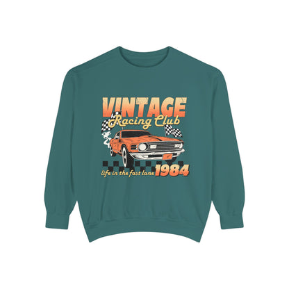 Retro car club shirt with vintage 1984 race car graphic, distressed design, and checkered flag accents. Perfect for muscle car lovers and fans of classic racing. Available as a crewneck sweatshirt in multiple colors.