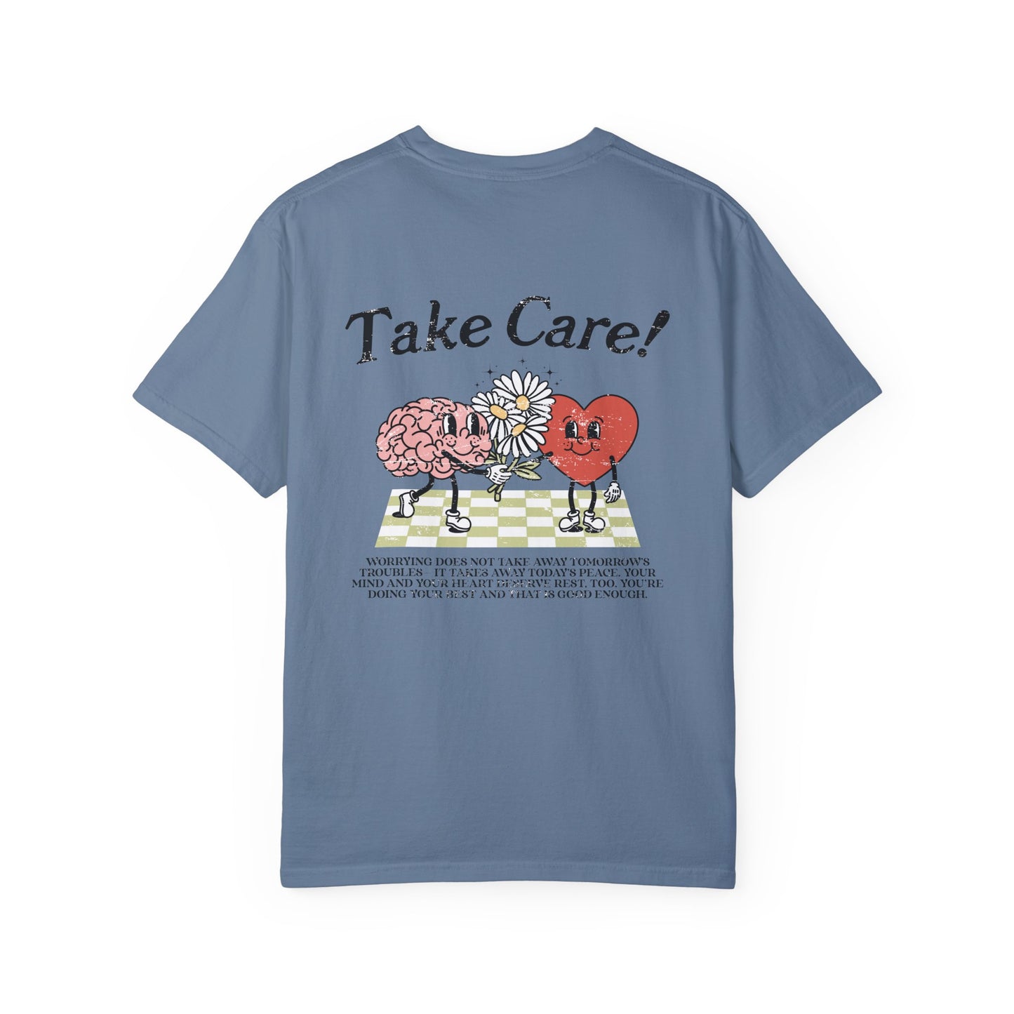 Graphic tee featuring a whimsical design with a heart and brain holding a flower, paired with motivational text encouraging self-care and positivity. Perfect for mental health awareness and retro-inspired casual style.