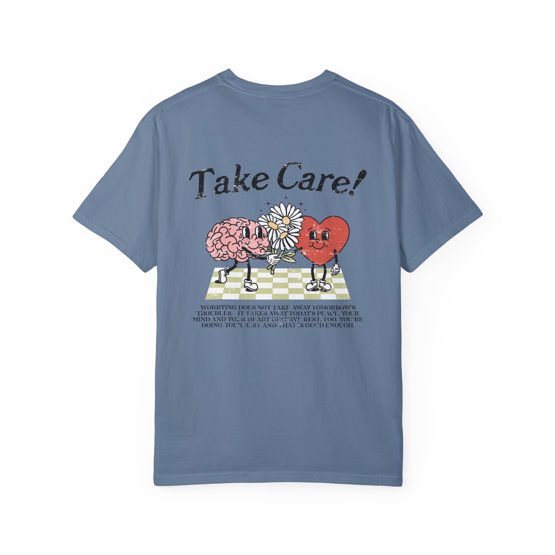 Graphic tee featuring a whimsical design with a heart and brain holding a flower, paired with motivational text encouraging self-care and positivity. Perfect for mental health awareness and retro-inspired casual style.