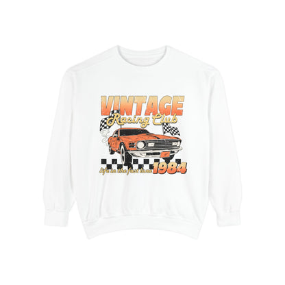 Retro car club shirt with vintage 1984 race car graphic, distressed design, and checkered flag accents. Perfect for muscle car lovers and fans of classic racing. Available as a crewneck sweatshirt in multiple colors.