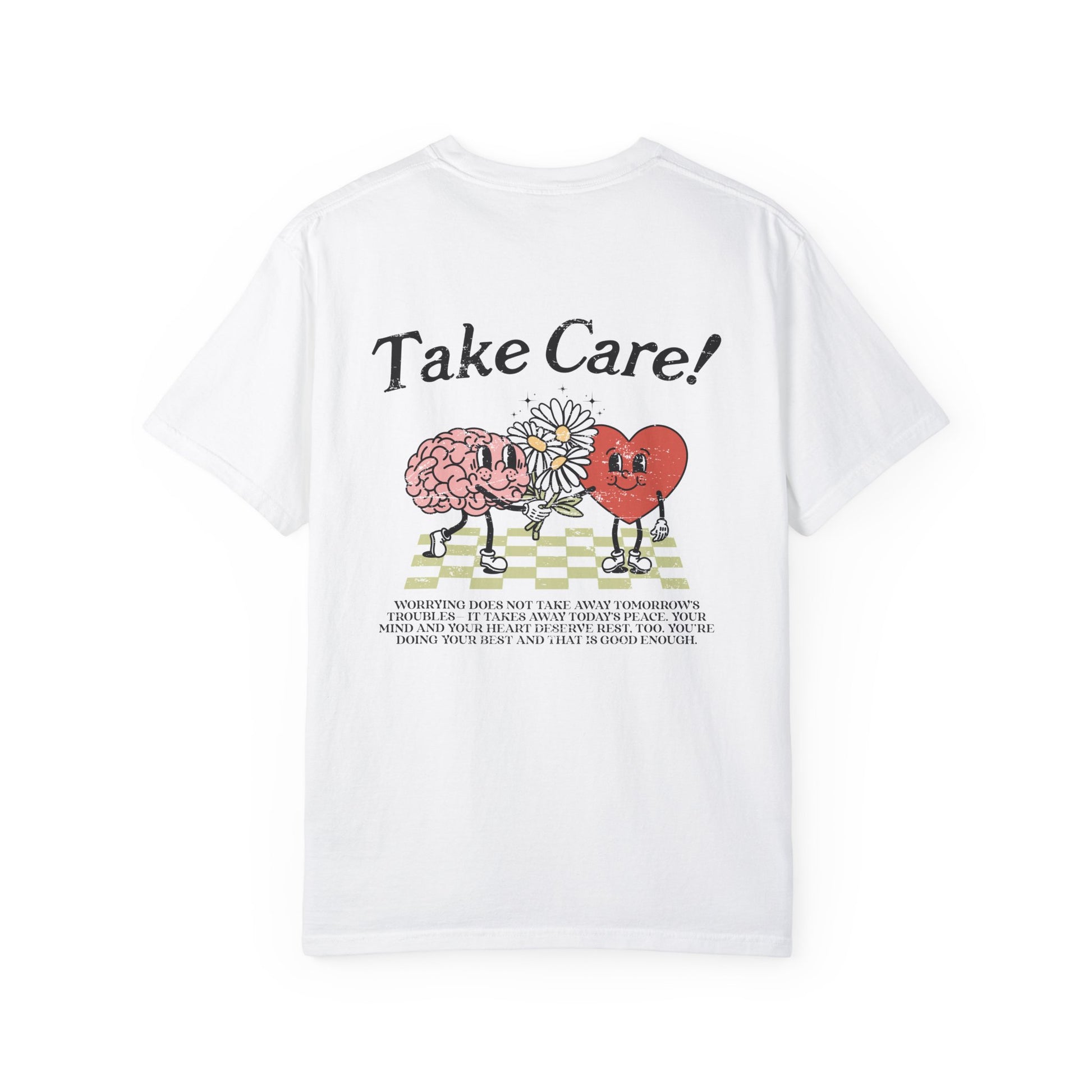 Graphic tee featuring a whimsical design with a heart and brain holding a flower, paired with motivational text encouraging self-care and positivity. Perfect for mental health awareness and retro-inspired casual style.