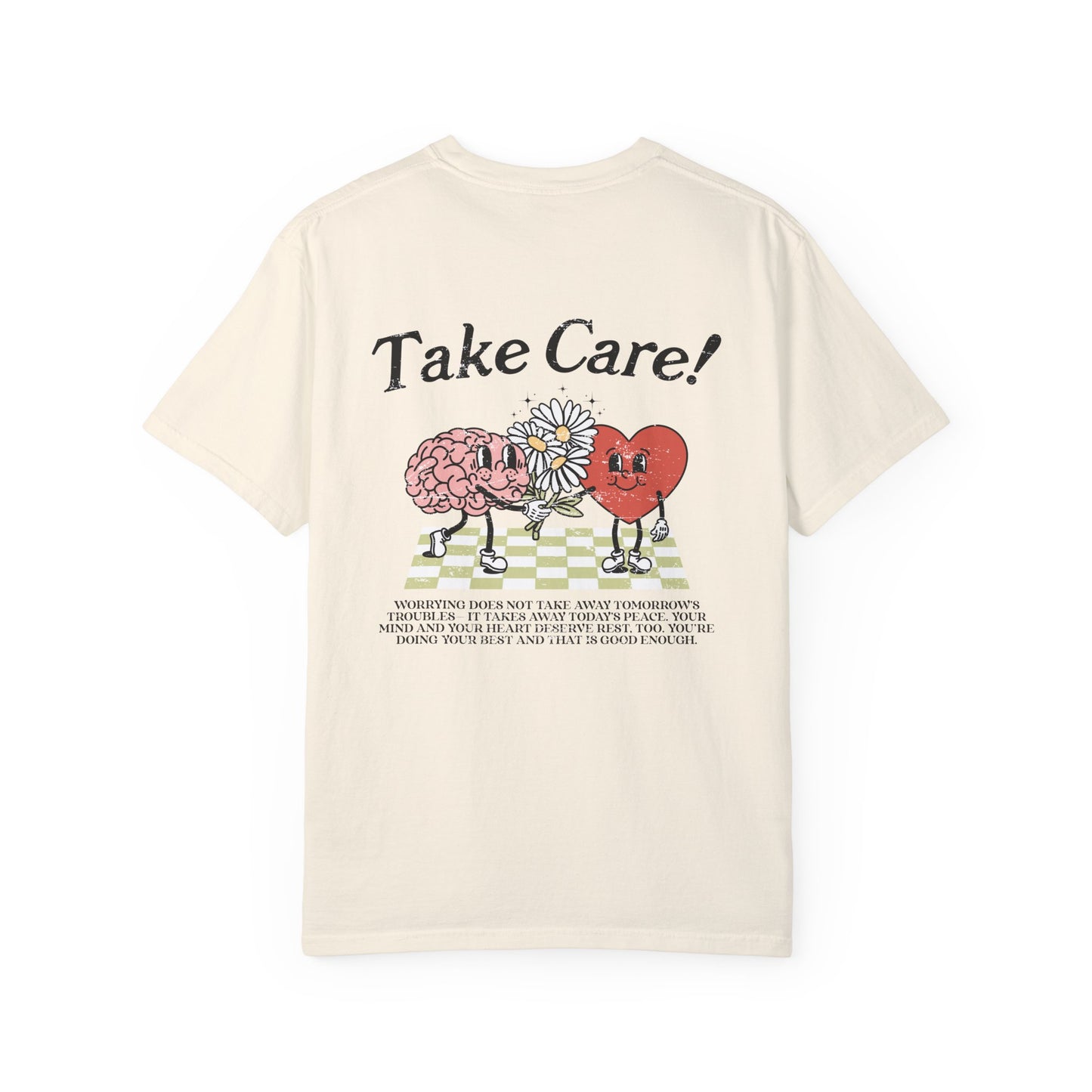 Graphic tee featuring a whimsical design with a heart and brain holding a flower, paired with motivational text encouraging self-care and positivity. Perfect for mental health awareness and retro-inspired casual style.