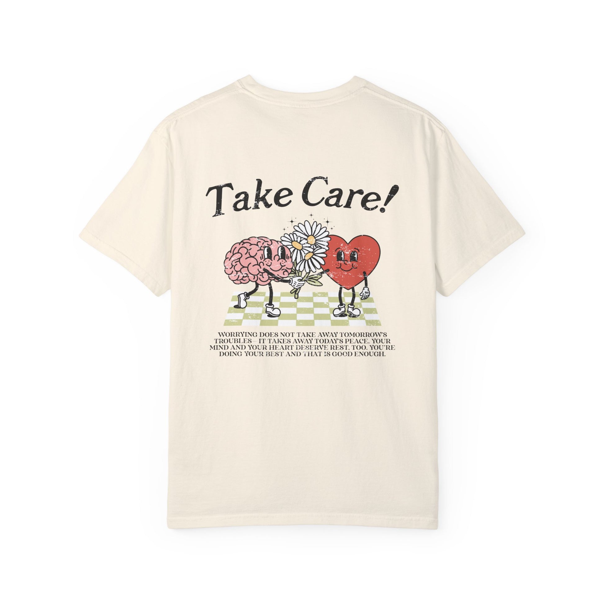 Graphic tee featuring a whimsical design with a heart and brain holding a flower, paired with motivational text encouraging self-care and positivity. Perfect for mental health awareness and retro-inspired casual style.