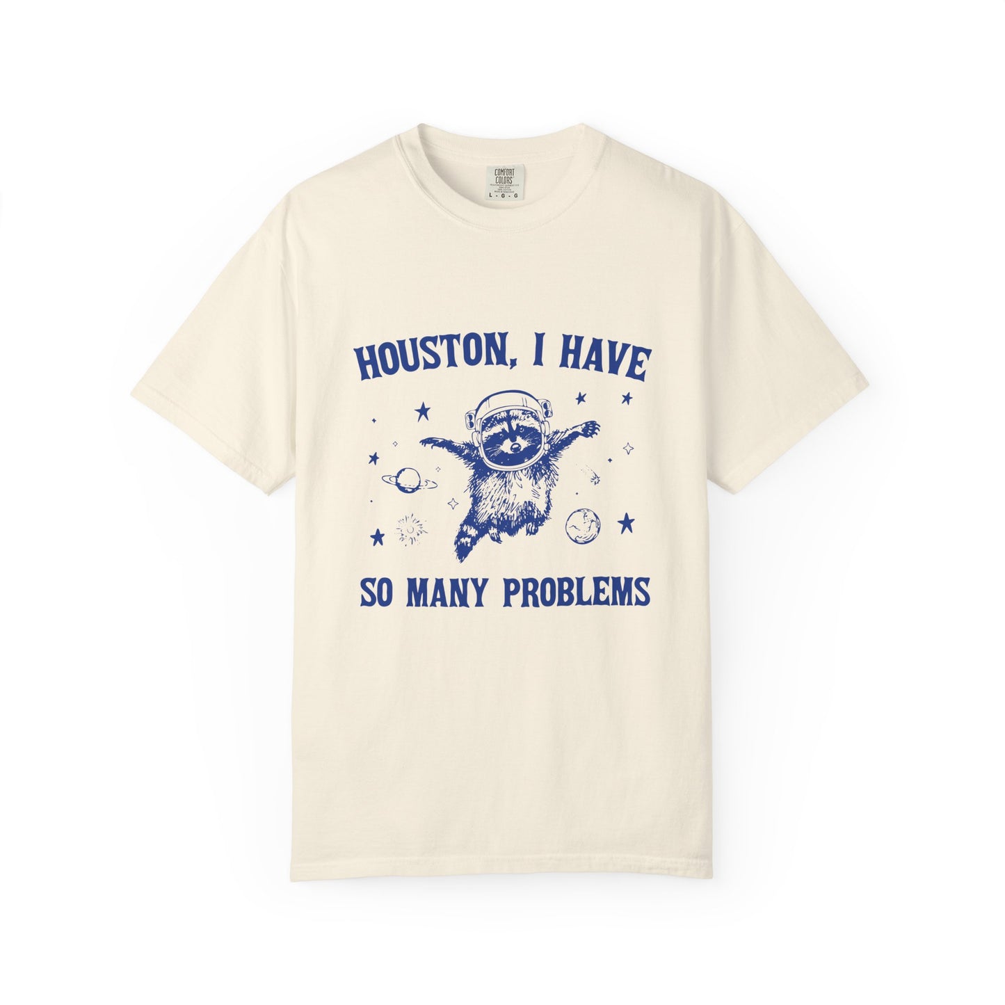 Beige t-shirt with blue graphic and text 'Houston, I have so many problems' on a white background