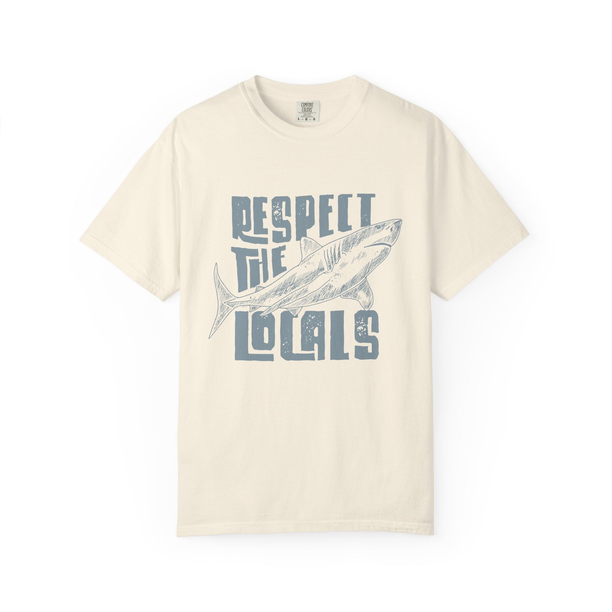 Beige t-shirt with a graphic of a fish and text 'Respect the Locals' on a white background