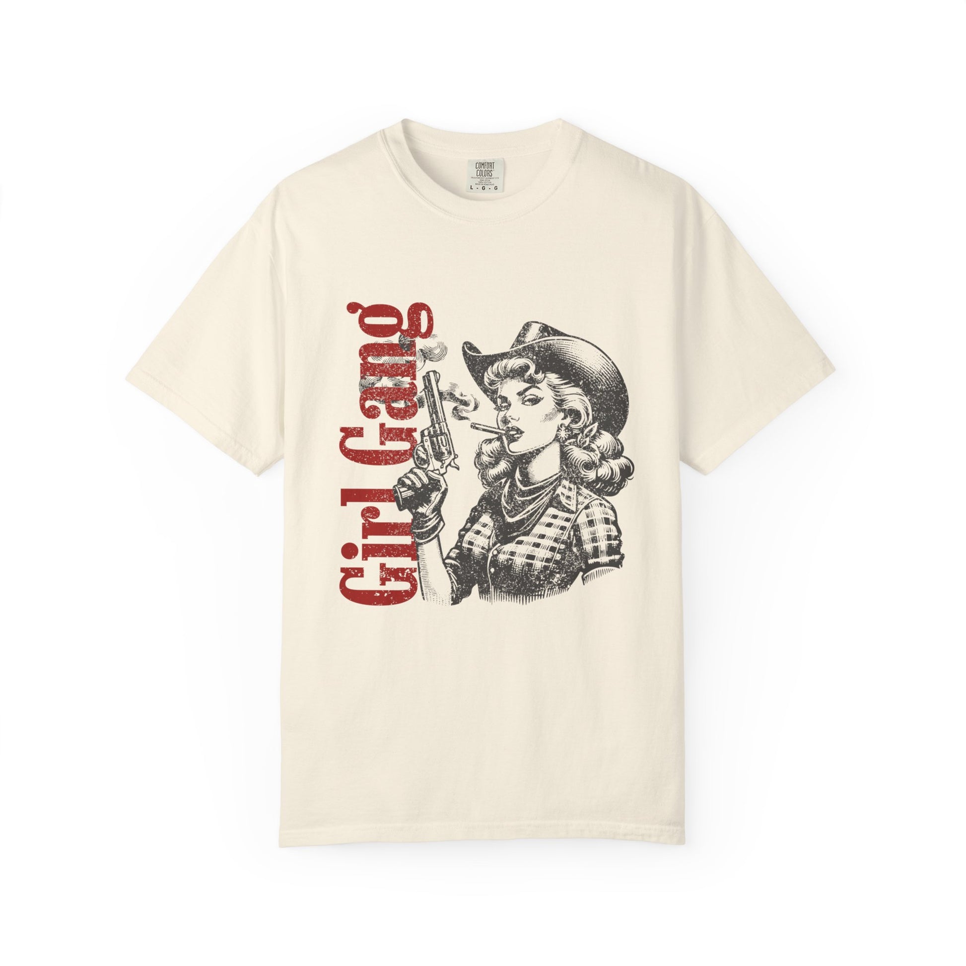 Beige t-shirt with graphic design of a woman in a cowboy hat and 'Girl Gang' text on a white background