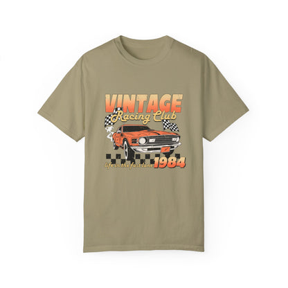 Retro racing T-shirt featuring a bold 1984 vintage design with distressed car graphics. Perfect nostalgic car shirt for muscle car lovers, featuring checkered flag details. Ideal for fans of old school racing and fast lane graphic tees.