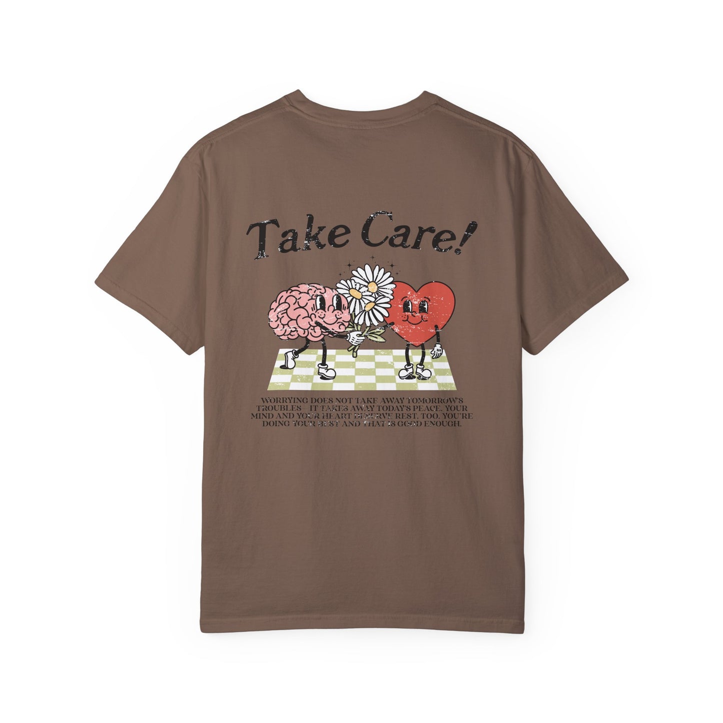 Graphic tee featuring a whimsical design with a heart and brain holding a flower, paired with motivational text encouraging self-care and positivity. Perfect for mental health awareness and retro-inspired casual style.
