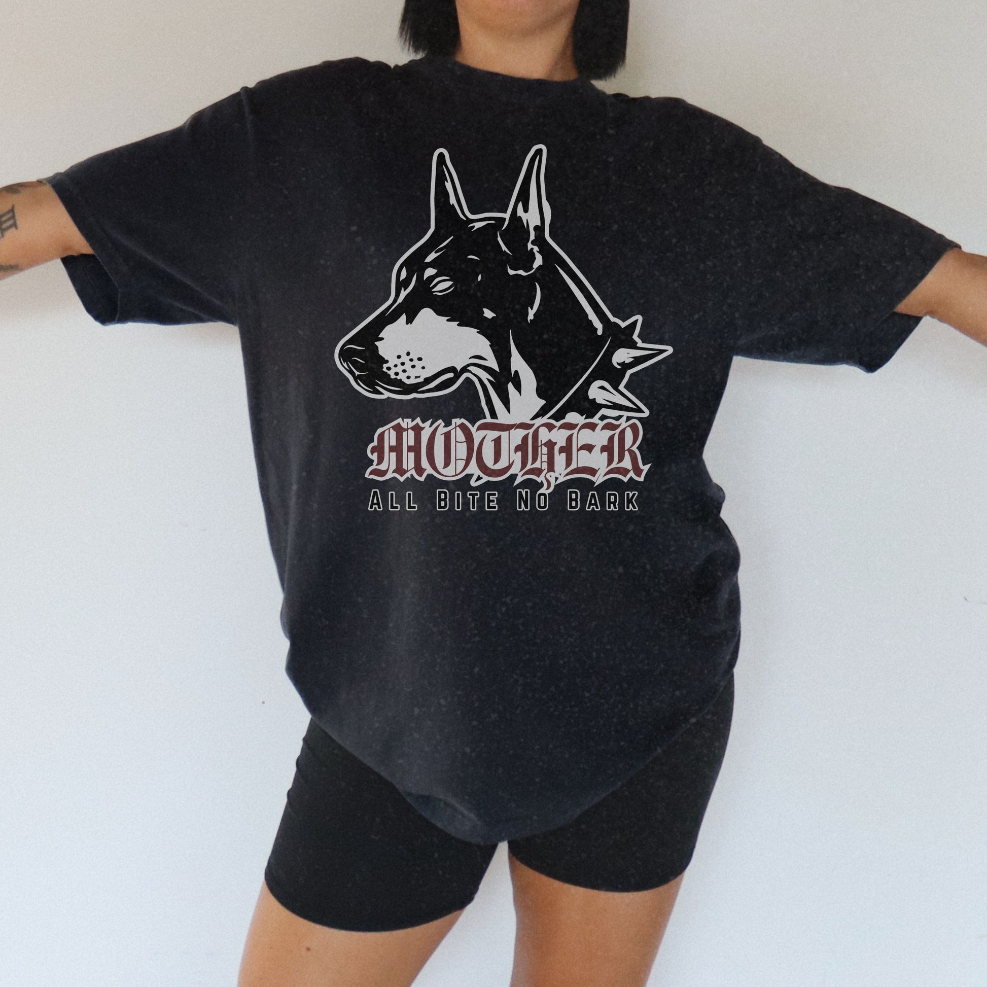 Oversized Doberman Graphic Tee with bold gothic lettering and tattoo style design. Edgy Dog Mom Shirt with punk rock vibe, perfect for streetwear lovers. Retro Mom Graphic Tee with All Bite No Bark statement for bold, confident moms.