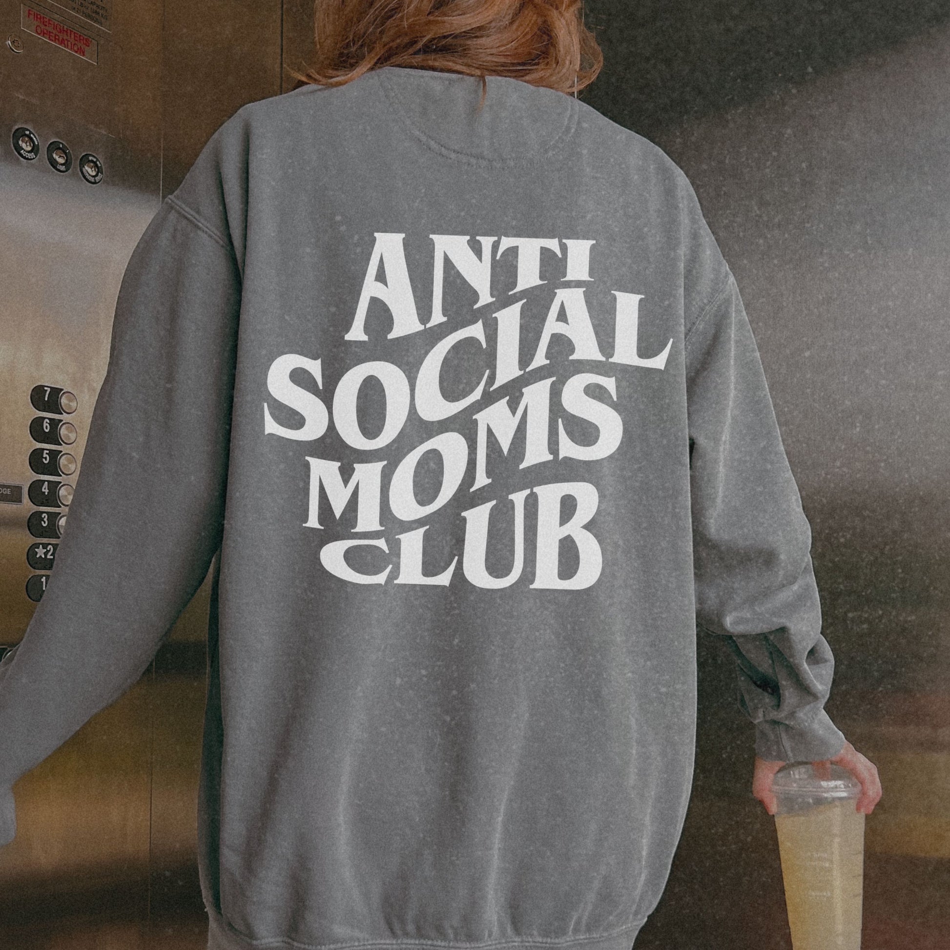 Anti Social Moms Club sweatshirt with bold graphic text on the back. Perfect funny mom sweatshirt or vintage mom pullover for casual wear. Stylish, oversized fit for a comfy mom sweatshirt, ideal gift for moms who love humor and relaxed style.