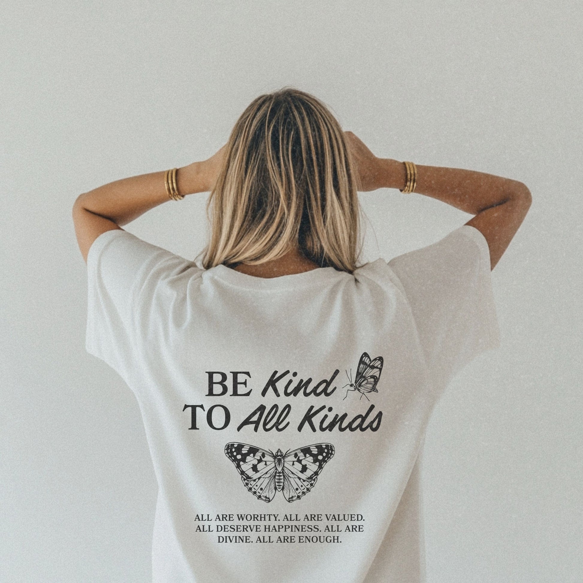 Be Kind Graphic Tee with butterfly design and uplifting message. Kindness Quote Tee made from soft cotton, perfect for casual wear. This Be Kind To All Tee spreads positivity and features an inspiring quote, great as a motivational shirt for daily style.