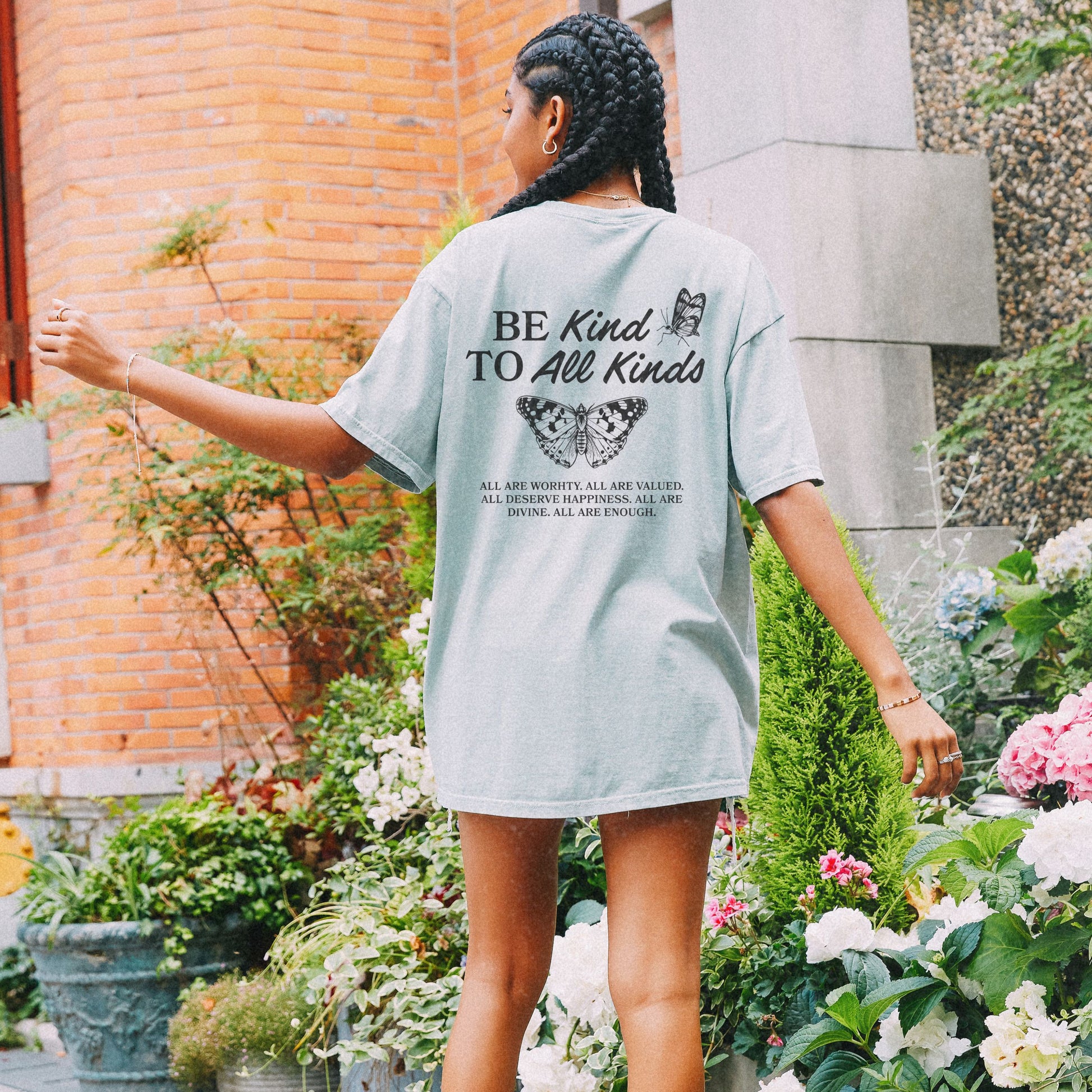 Be Kind Graphic Tee with butterfly design and uplifting message. Kindness Quote Tee made from soft cotton, perfect for casual wear. This Be Kind To All Tee spreads positivity and features an inspiring quote, great as a motivational shirt for daily style.