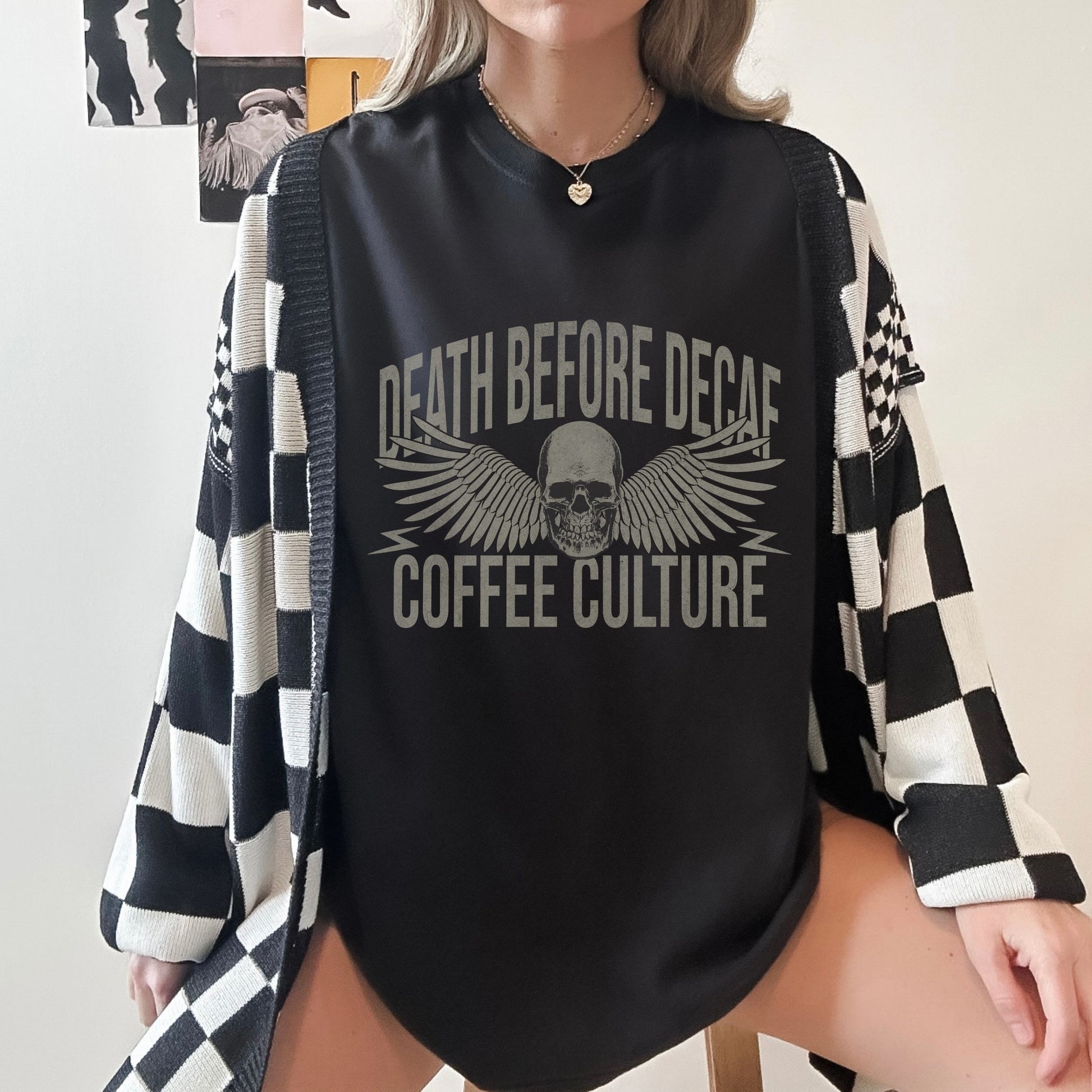 T-shirt with bold Death Before Decaf design featuring a skull and wings. Perfect for coffee lovers who prefer strong brews. This edgy coffee skull shirt makes a great caffeine addict tee or anti decaf shirt. Fits unisex style and works as a vintage coffee tee, goth coffee shirt, or strong coffee shirt. Ideal for casual wear, gifting, or making a bold coffee culture statement. Funny coffee shirt with attitude.