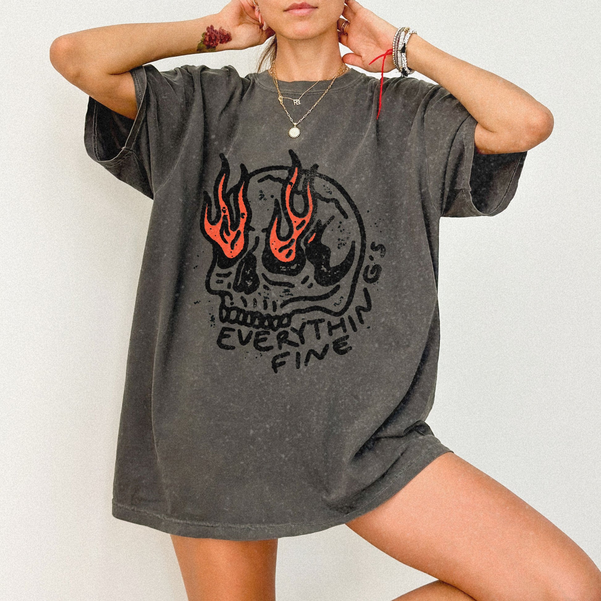 Distressed Skull Graphic T-Shirt with flames and bold grunge design. Oversized fit offers comfort and vintage-inspired edge for casual or streetwear outfits. 