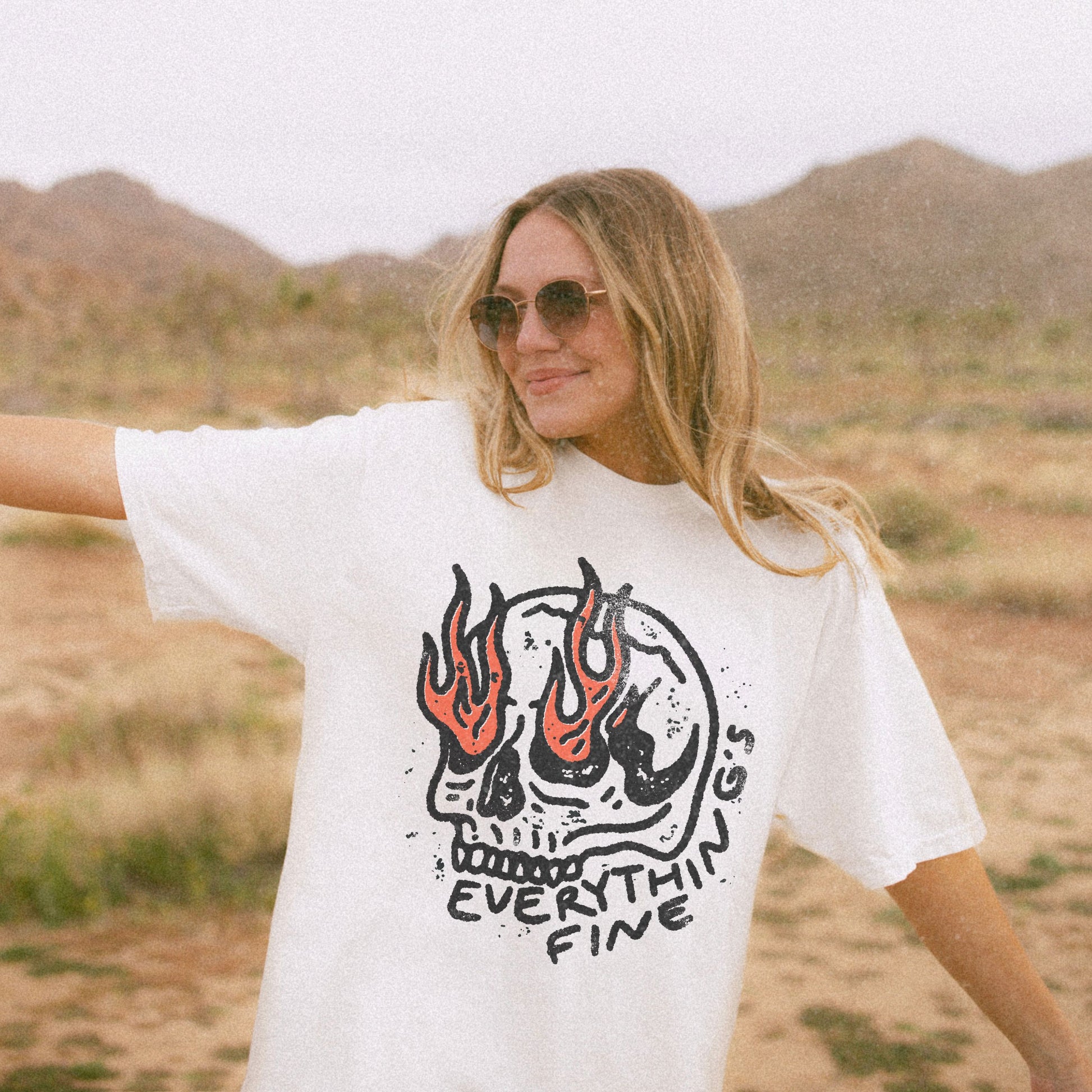 Distressed Skull Graphic T-Shirt with flames and bold grunge design. Oversized fit offers comfort and vintage-inspired edge for casual or streetwear outfits. 