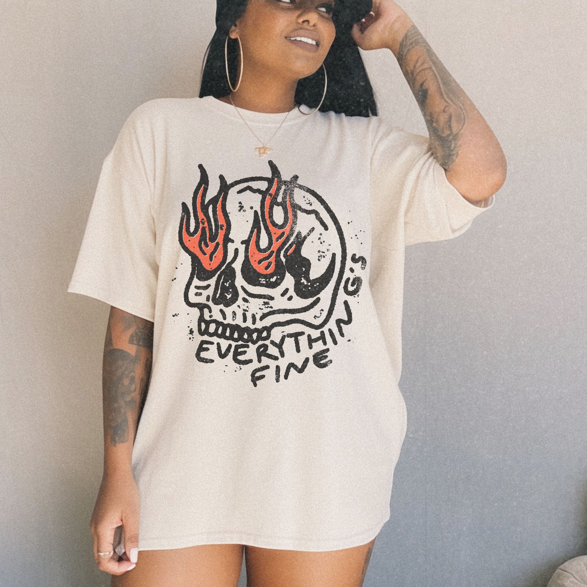 Distressed Skull Graphic T-Shirt with flames and bold grunge design. Oversized fit offers comfort and vintage-inspired edge for casual or streetwear outfits. 