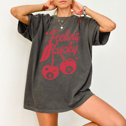 Shirt featuring a lucky cherry graphic with vintage red cherries and an 8-ball design. Retro cherry t-shirt with a feeling lucky vibe, perfect as a black vintage shirt or fun vintage shirt for casual, stylish looks.