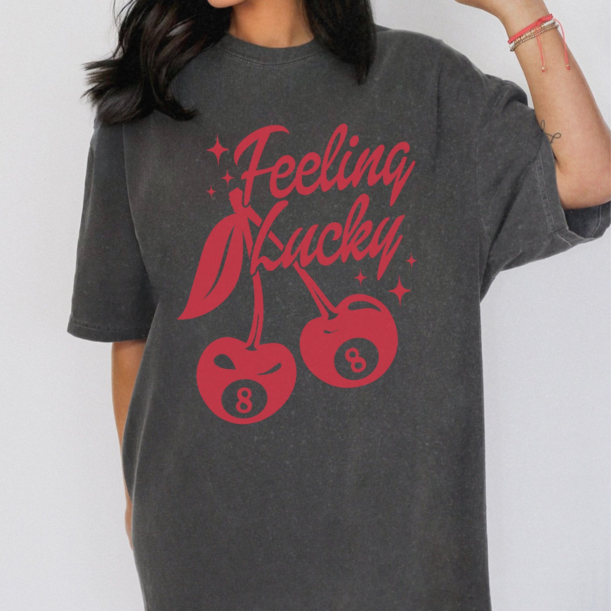 Shirt featuring a lucky cherry graphic with vintage red cherries and an 8-ball design. Retro cherry t-shirt with a feeling lucky vibe, perfect as a black vintage shirt or fun vintage shirt for casual, stylish looks.