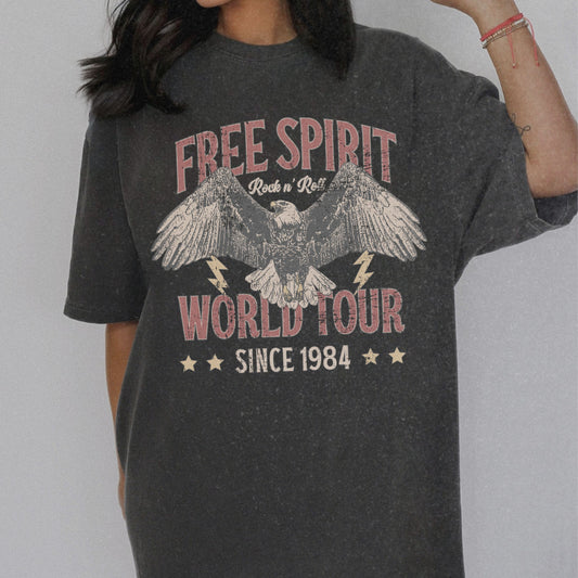 Vintage tour shirt with eagle graphic, distressed details, and 1984 band tour text, perfect for lovers of retro graphic tees, rock and roll shirts, and oversized styles. Casual vintage tee with bold lightning bolt accents.