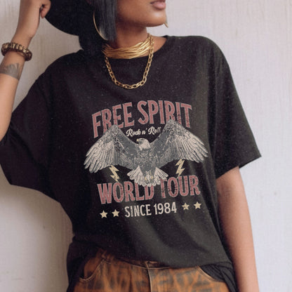 Vintage tour shirt with eagle graphic, distressed details, and 1984 band tour text, perfect for lovers of retro graphic tees, rock and roll shirts, and oversized styles. Casual vintage tee with bold lightning bolt accents.