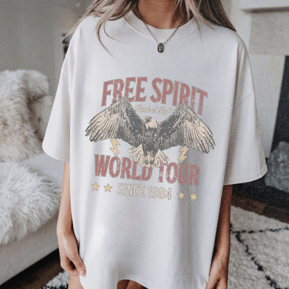 Vintage tour shirt with eagle graphic, distressed details, and 1984 band tour text, perfect for lovers of retro graphic tees, rock and roll shirts, and oversized styles. Casual vintage tee with bold lightning bolt accents.