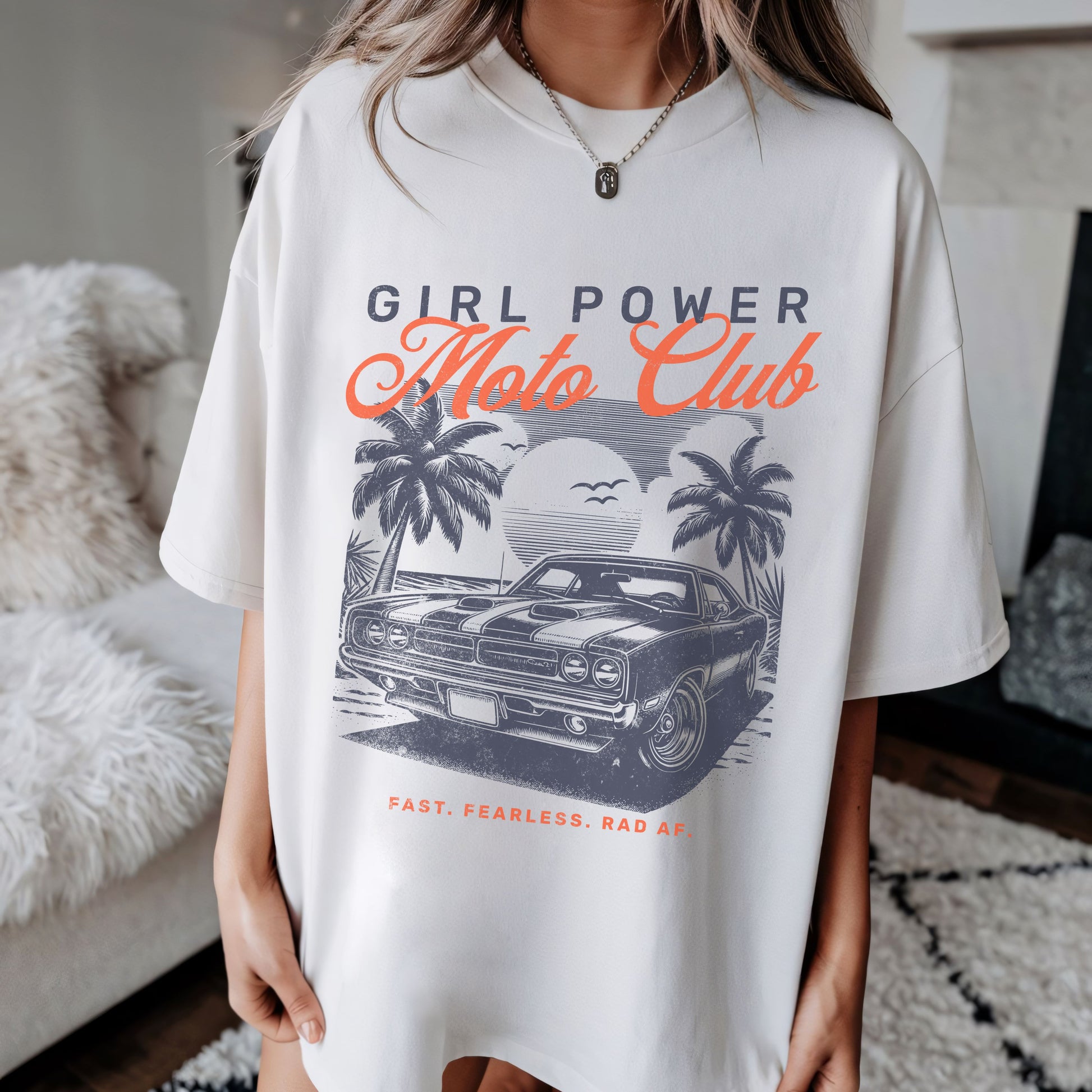 Person wearing a white t-shirt with 'Girl Power Moto Club' graphic design.