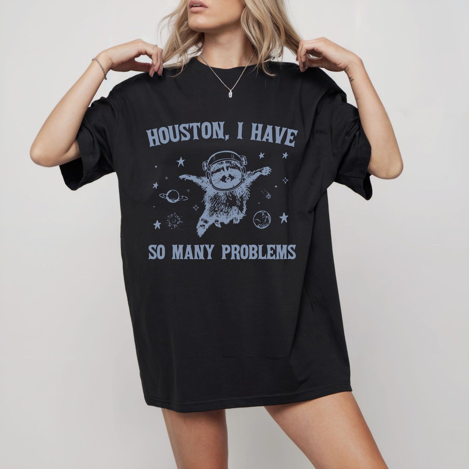 Black t-shirt with humorous graphic and text worn by a model on a plain background