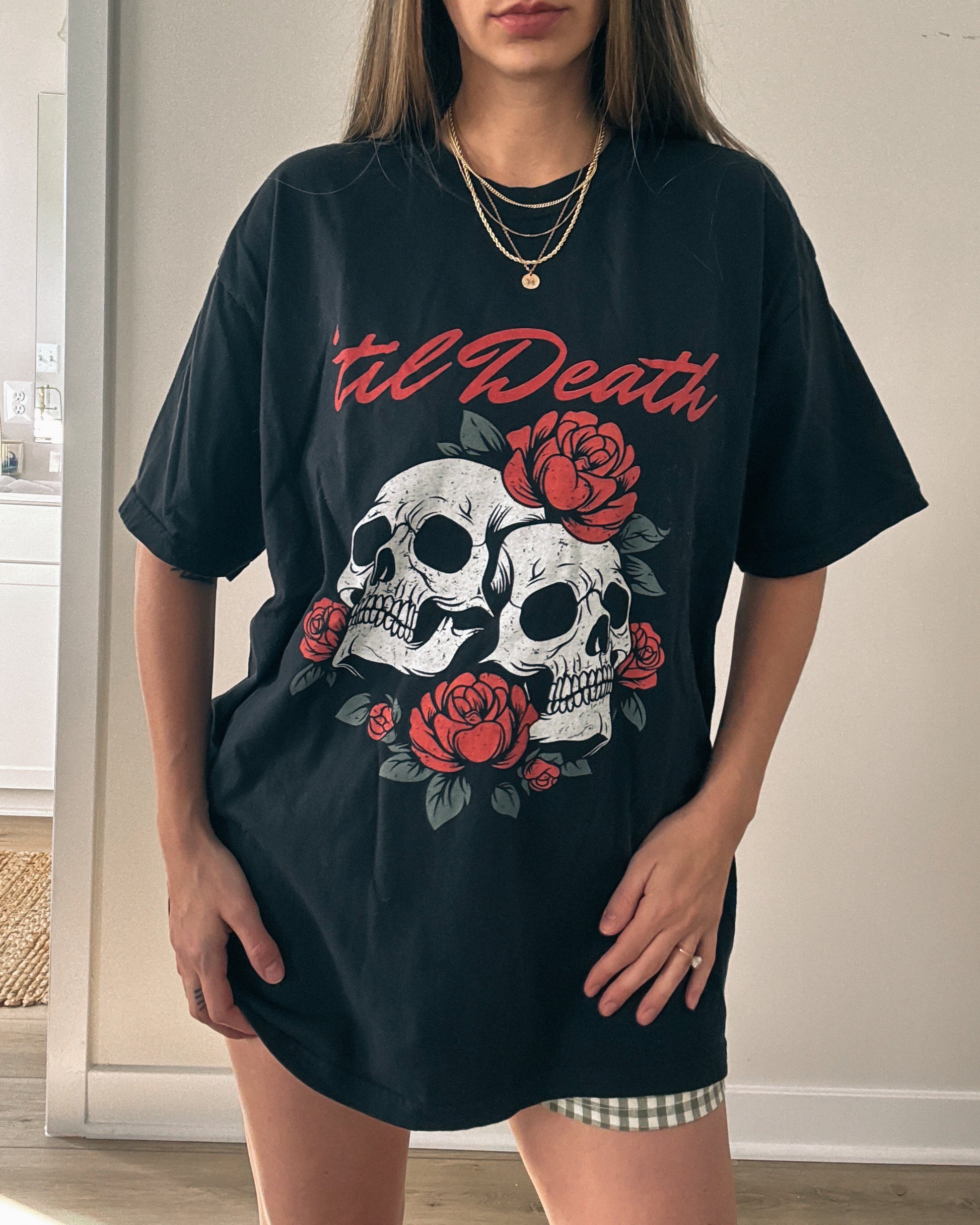 Graphic tee featuring a bold skull and roses design with vintage-inspired details. Perfect for fans of retro skeleton shirts, romantic gothic skull tees, or punk skull rose graphics. A unique aesthetic tattoo skull tee for edgy and dark romance lovers.