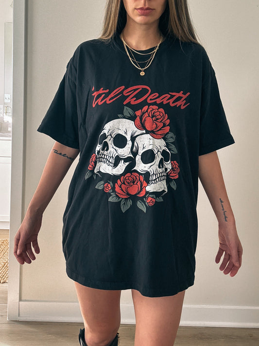 Graphic tee featuring a bold skull and roses design with vintage-inspired details. Perfect for fans of retro skeleton shirts, romantic gothic skull tees, or punk skull rose graphics. A unique aesthetic tattoo skull tee for edgy and dark romance lovers.