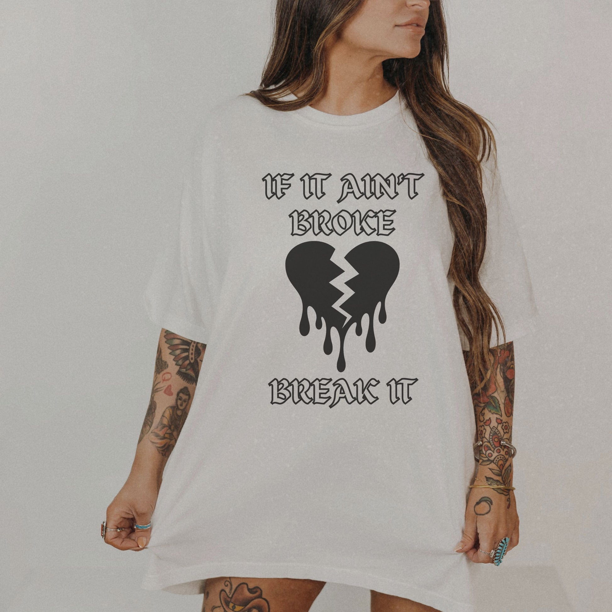T-shirt with bold gothic-style text 'If It Ain't Broke, Break It' and dripping broken heart graphic. Perfect for rebellious fashion, Valentine’s Day outfit ideas, edgy streetwear style, and bold statement graphic tees.