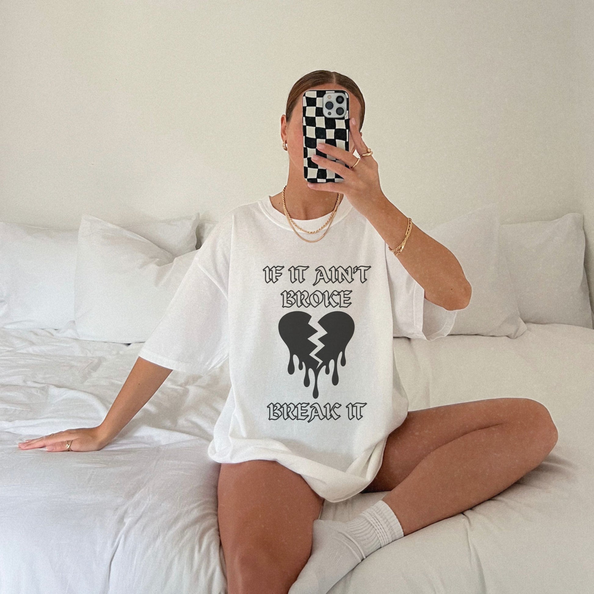 T-shirt with bold gothic-style text 'If It Ain't Broke, Break It' and dripping broken heart graphic. Perfect for rebellious fashion, Valentine’s Day outfit ideas, edgy streetwear style, and bold statement graphic tees.
