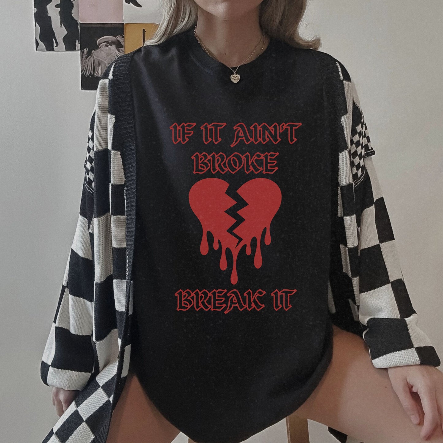 T-shirt with bold gothic-style text 'If It Ain't Broke, Break It' and dripping broken heart graphic. Perfect for rebellious fashion, Valentine’s Day outfit ideas, edgy streetwear style, and bold statement graphic tees.