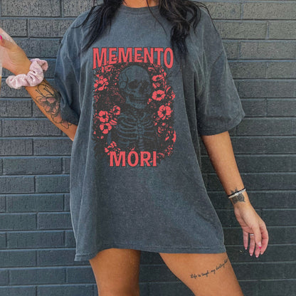 Graphic tee featuring a detailed skull design surrounded by floral elements, perfect for fans of vintage skeleton tees, gothic skull shirts, and retro goth style. A trendy death-themed shirt combining dark floral and skeleton art for casual or streetwear looks.