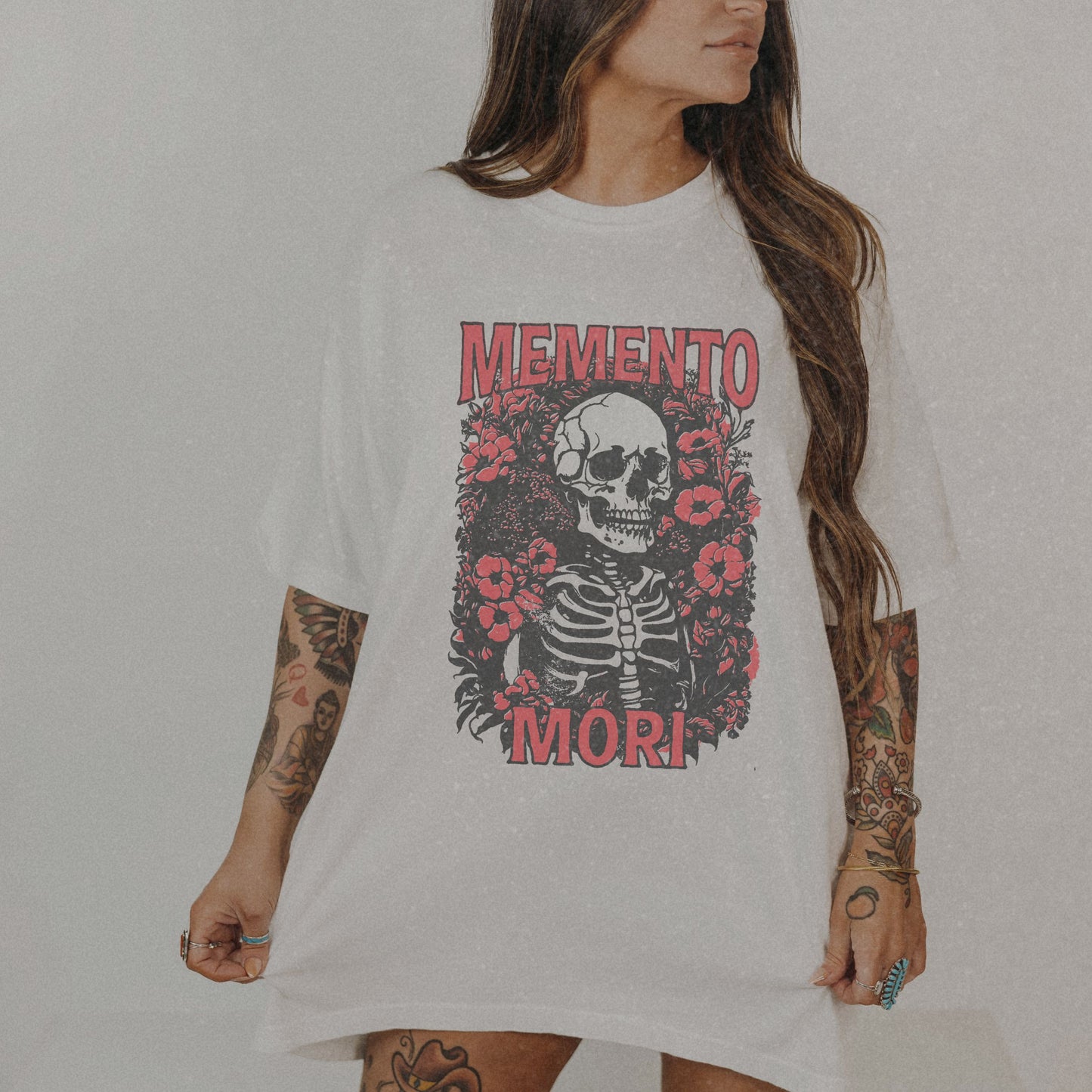 Graphic tee featuring a detailed skull design surrounded by floral elements, perfect for fans of vintage skeleton tees, gothic skull shirts, and retro goth style. A trendy death-themed shirt combining dark floral and skeleton art for casual or streetwear looks.