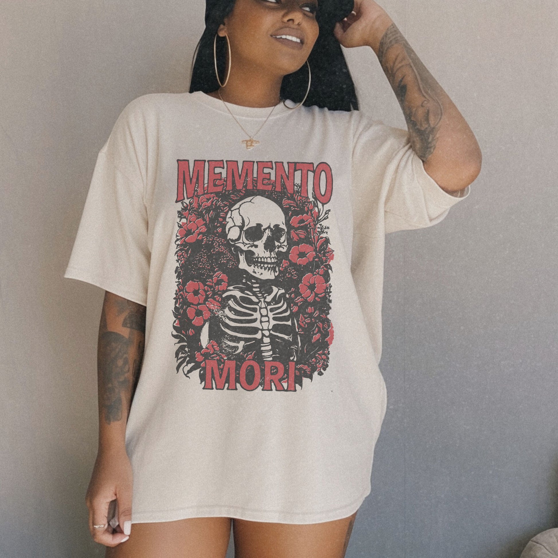 Graphic tee featuring a detailed skull design surrounded by floral elements, perfect for fans of vintage skeleton tees, gothic skull shirts, and retro goth style. A trendy death-themed shirt combining dark floral and skeleton art for casual or streetwear looks.