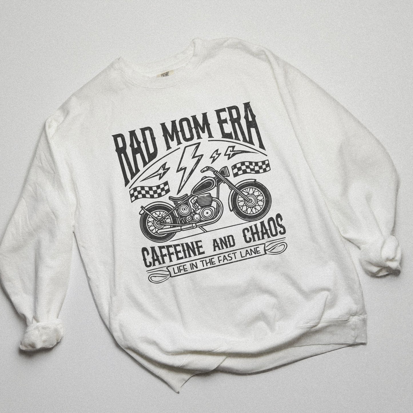 Rad mom graphic tee featuring a vintage motorcycle design with bold text. Perfect for edgy mom style, this trendy mom sweatshirt embodies caffeine chaos vibes and retro mom life. Great for biker moms or stylish moms seeking a casual yet bold look.