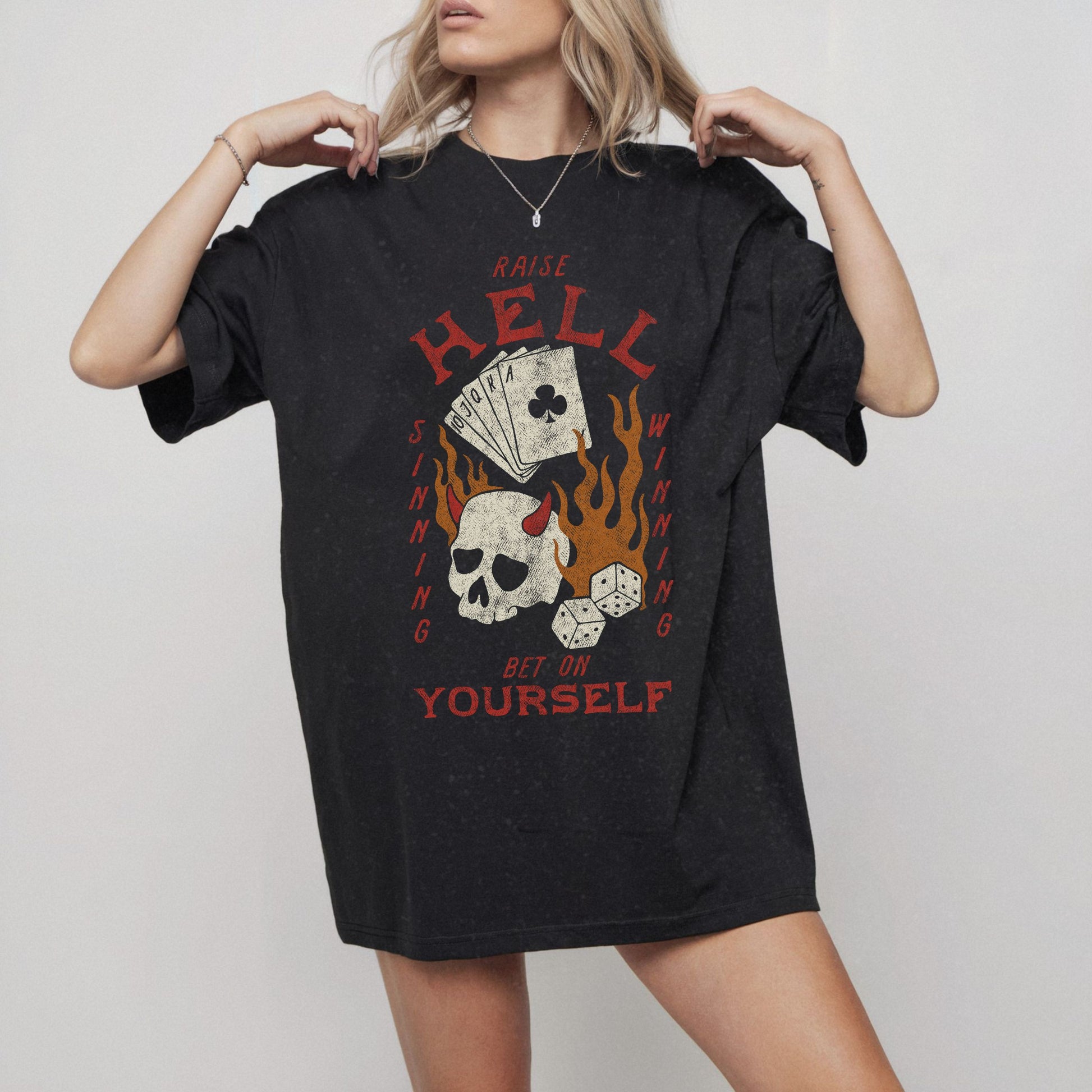 Vintage skull tee with a hellfire graphic, outlaw poker design, and flaming dice. Edgy gambling shirt with tattoo style skull, gothic aesthetic, and punk rock vibe. Retro casino shirt for risk-takers who love badass dice graphics and dark streetwear fashion.