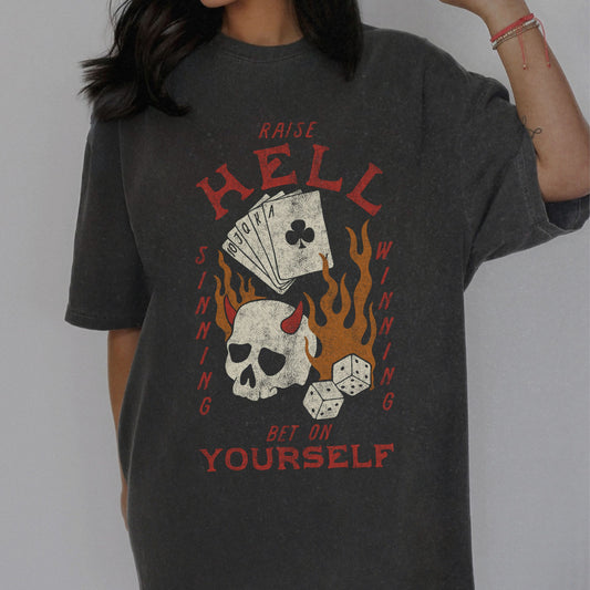 Vintage skull tee with a hellfire graphic, outlaw poker design, and flaming dice. Edgy gambling shirt with tattoo style skull, gothic aesthetic, and punk rock vibe. Retro casino shirt for risk-takers who love badass dice graphics and dark streetwear fashion.