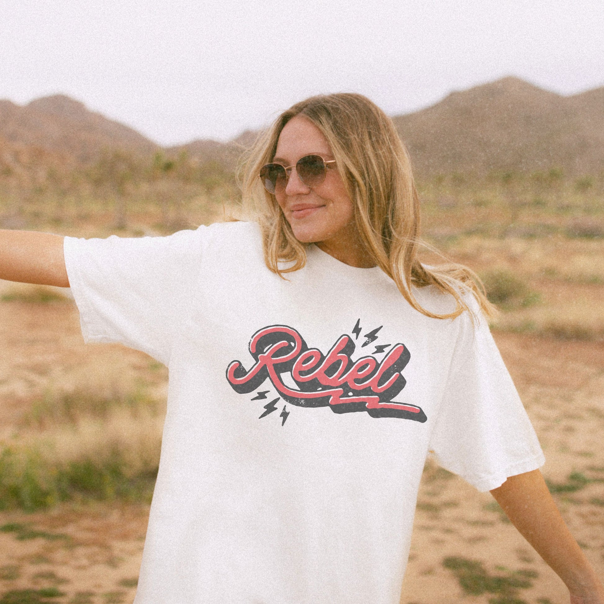 Retro Rebel Tee with vintage-inspired graphic and lightning bolt design. Oversized Rebel Tee perfect for streetwear or casual looks. Distressed Rebel Tee for 90s vibes. Bold Rebel Graphic Tee for a statement style. Ideal for everyday wear with a cool edge.