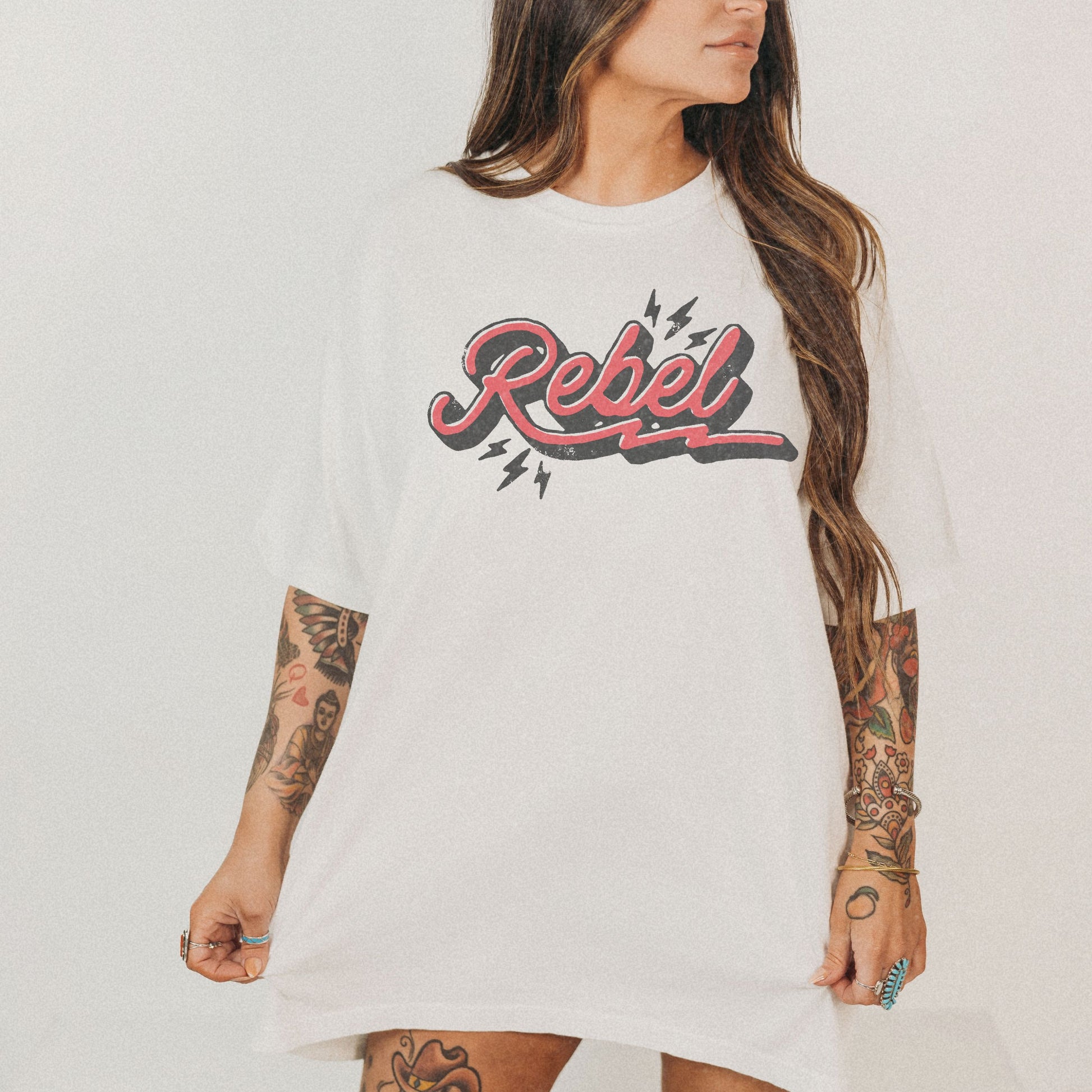 Retro Rebel Tee with vintage-inspired graphic and lightning bolt design. Oversized Rebel Tee perfect for streetwear or casual looks. Distressed Rebel Tee for 90s vibes. Bold Rebel Graphic Tee for a statement style. Ideal for everyday wear with a cool edge.