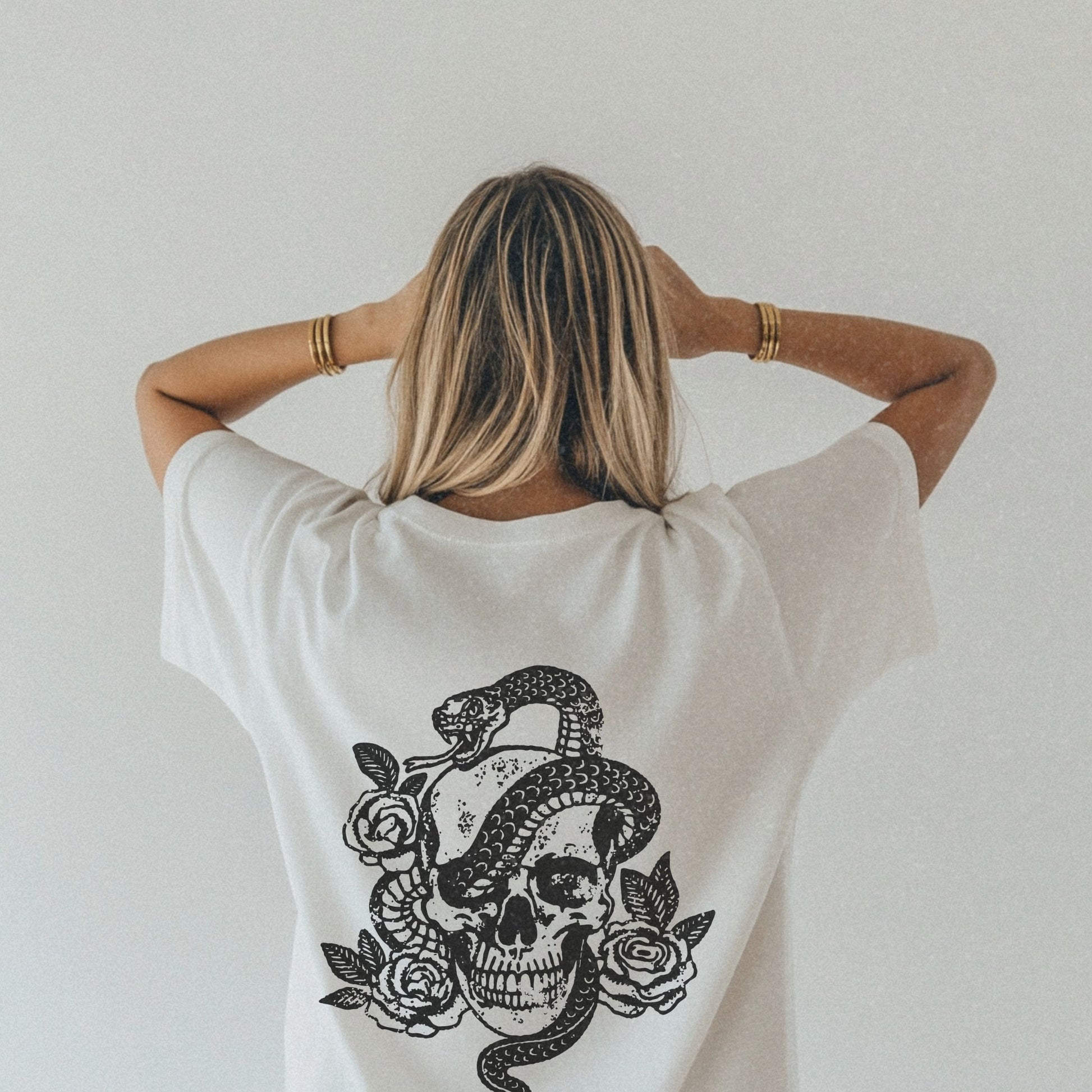 Snake skull shirt with a bold skull, rose, and snake design, blending edgy and gothic vibes. This dark graphic tee is ideal for fans of retro snake shirts, witchy skeleton tees, or unique rose t-shirts seeking a vintage gothic aesthetic for everyday wear.