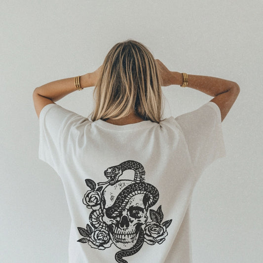 Snake skull shirt with a bold skull, rose, and snake design, blending edgy and gothic vibes. This dark graphic tee is ideal for fans of retro snake shirts, witchy skeleton tees, or unique rose t-shirts seeking a vintage gothic aesthetic for everyday wear.