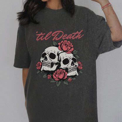 Graphic tee featuring a bold skull and roses design with vintage-inspired details. Perfect for fans of retro skeleton shirts, romantic gothic skull tees, or punk skull rose graphics. A unique aesthetic tattoo skull tee for edgy and dark romance lovers.